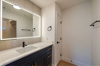 A bathroom with a sink and mirror.